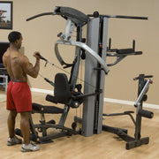 Male athlete uses Body-Solid Fusion 500 Home Gym with 210-Pound Weight Stack F500-2 for arm curls. 
