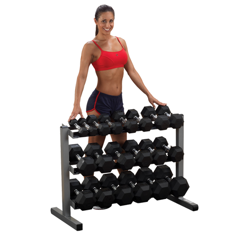 Female athlete stands behind Body-Solid 3 Tier Horizontal Dumbbell Rack GDR363