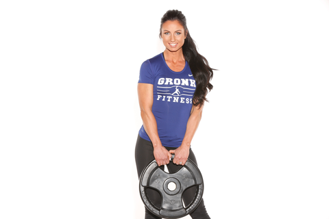 Female athlete in gRonk Fitness shirt holds Multi-Grip Virgin Rubber Olympic Plates
