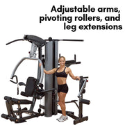 Female athlete stands with Body-Solid Fusion 500 Home Gym with 210-Pound Weight Stack F500-2. Adjustable arms, pivoting rollers and leg extensions available. 