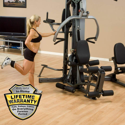 Female athlete uses Body-Solid Fusion 500 Home Gym with 210-Pound Weight Stack F500-2 for leg curl. Lifetime Warranty available from Body Solid. 