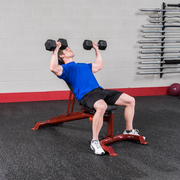 Male athlete uses BODY-SOLID FLAT INCLINE DECLINE BENCH for incline dumbbell bench press