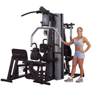 Female athlete stands next to Body-Solid G9S Two-Stack Gym
