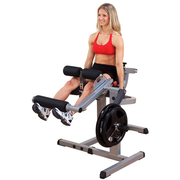Female athlete uses Body-Solid CAM Series Seated Leg Extension Seated Leg Curl machine GCEC340 for leg extension. 