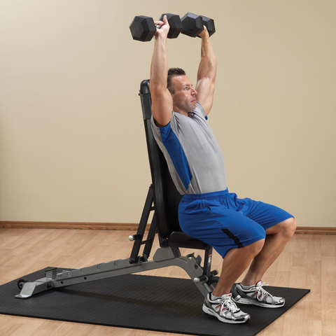 Male athlete uses Body-Solid Pro Club Line Adjustable FID Bench SFID325 for vertical dumbbell press exercise. 