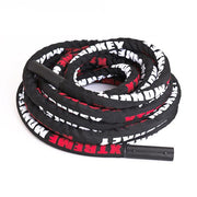 Black Xtreme Monkey battle rope in curled position. 